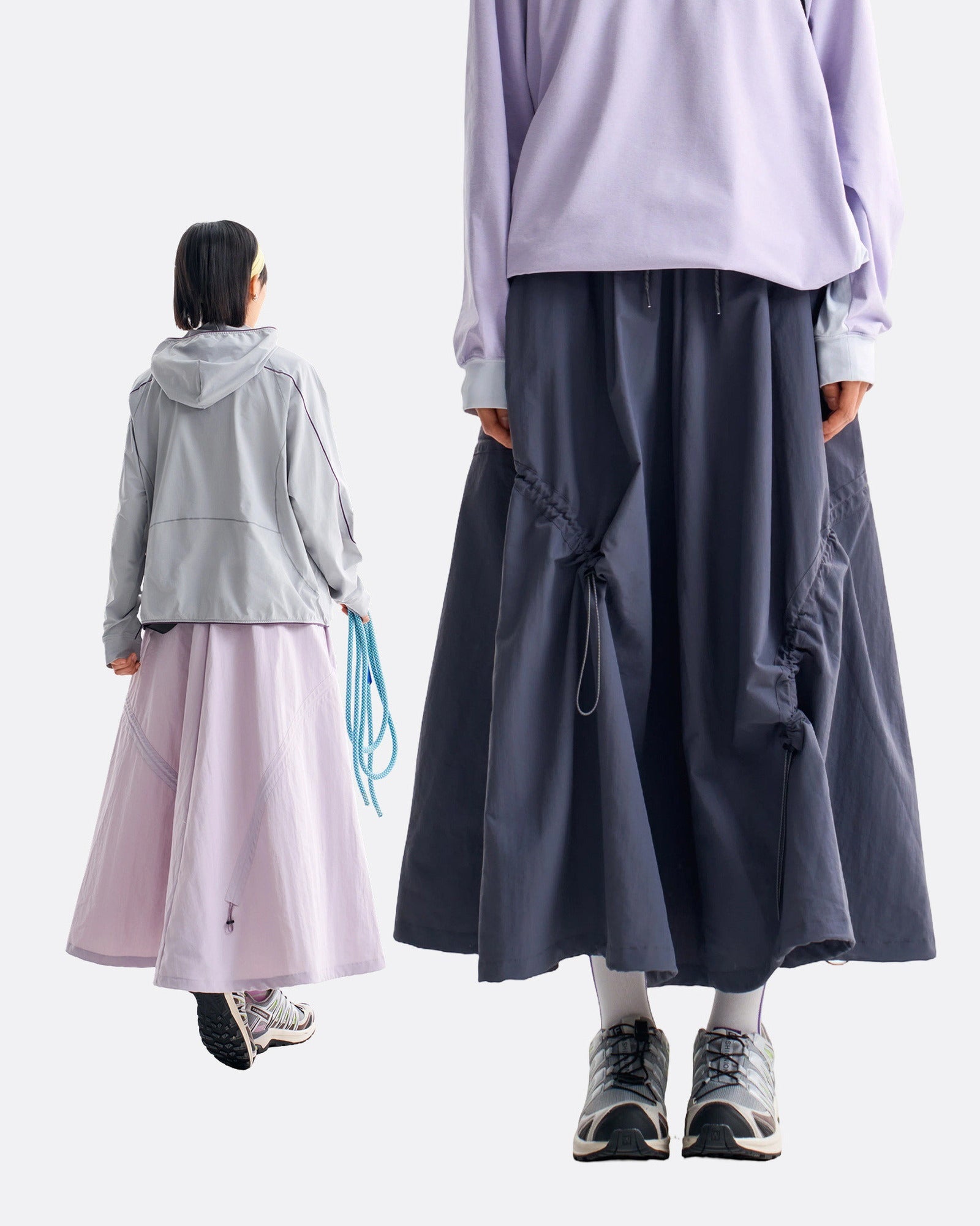 Back view of violet mist and ink blue technical cargo skirts showing rear drawstring and full flared hem