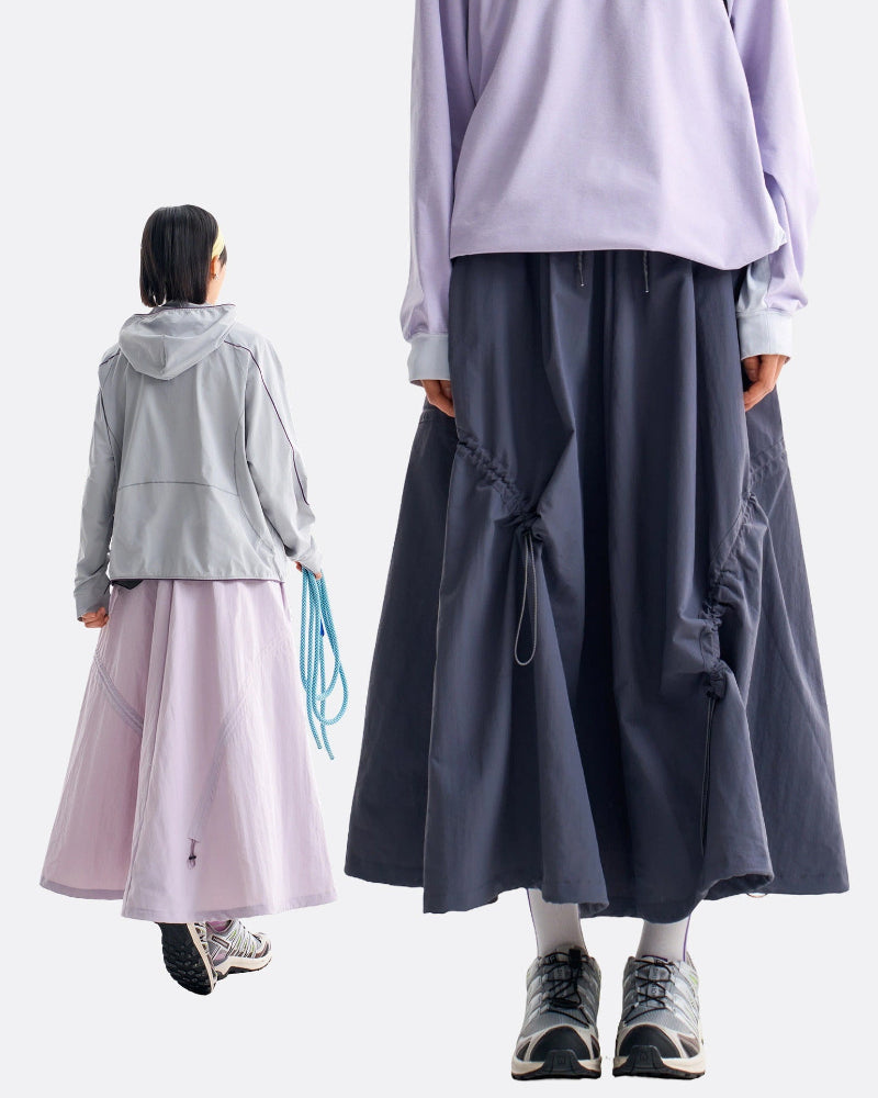 Back view of violet mist and ink blue technical cargo skirts showing rear drawstring and full flared hem