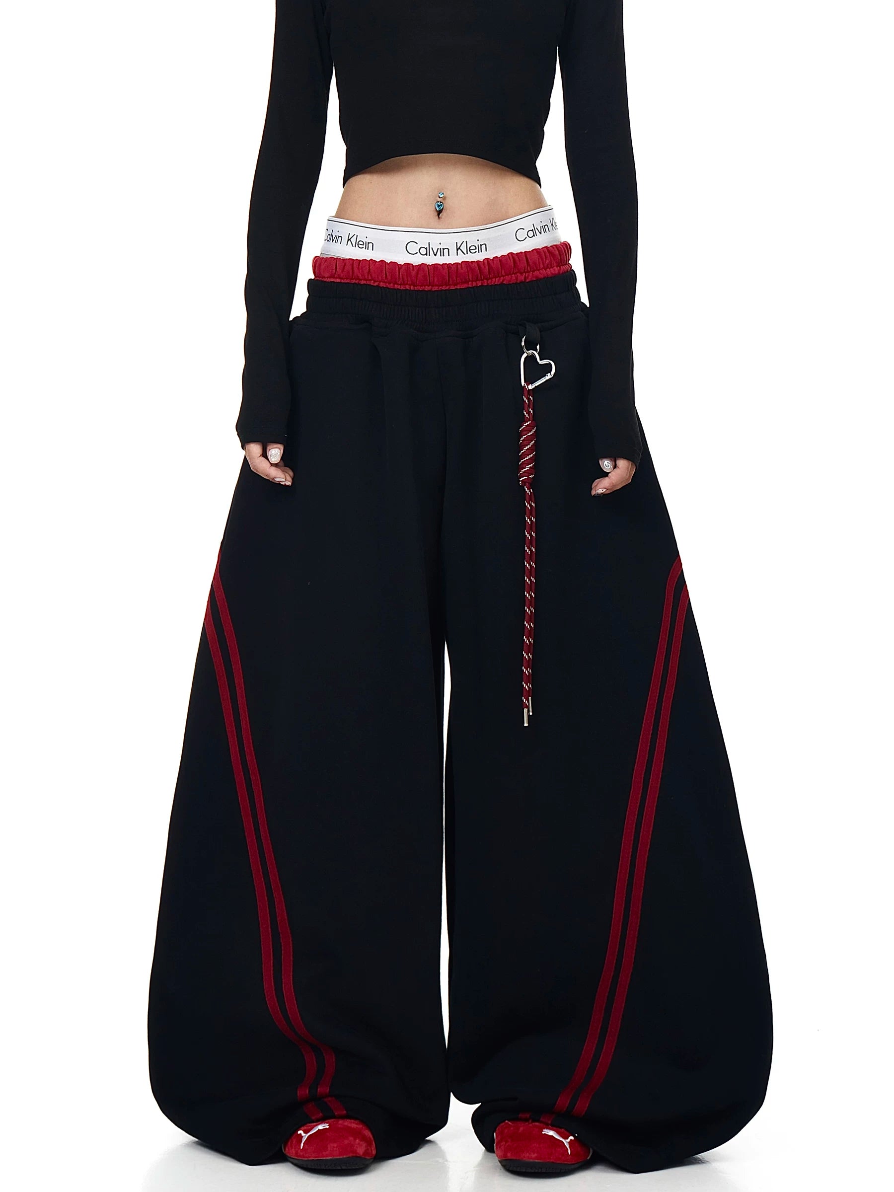Model wearing black striped curved wide-leg sweatpants, front view - Techwearofficial