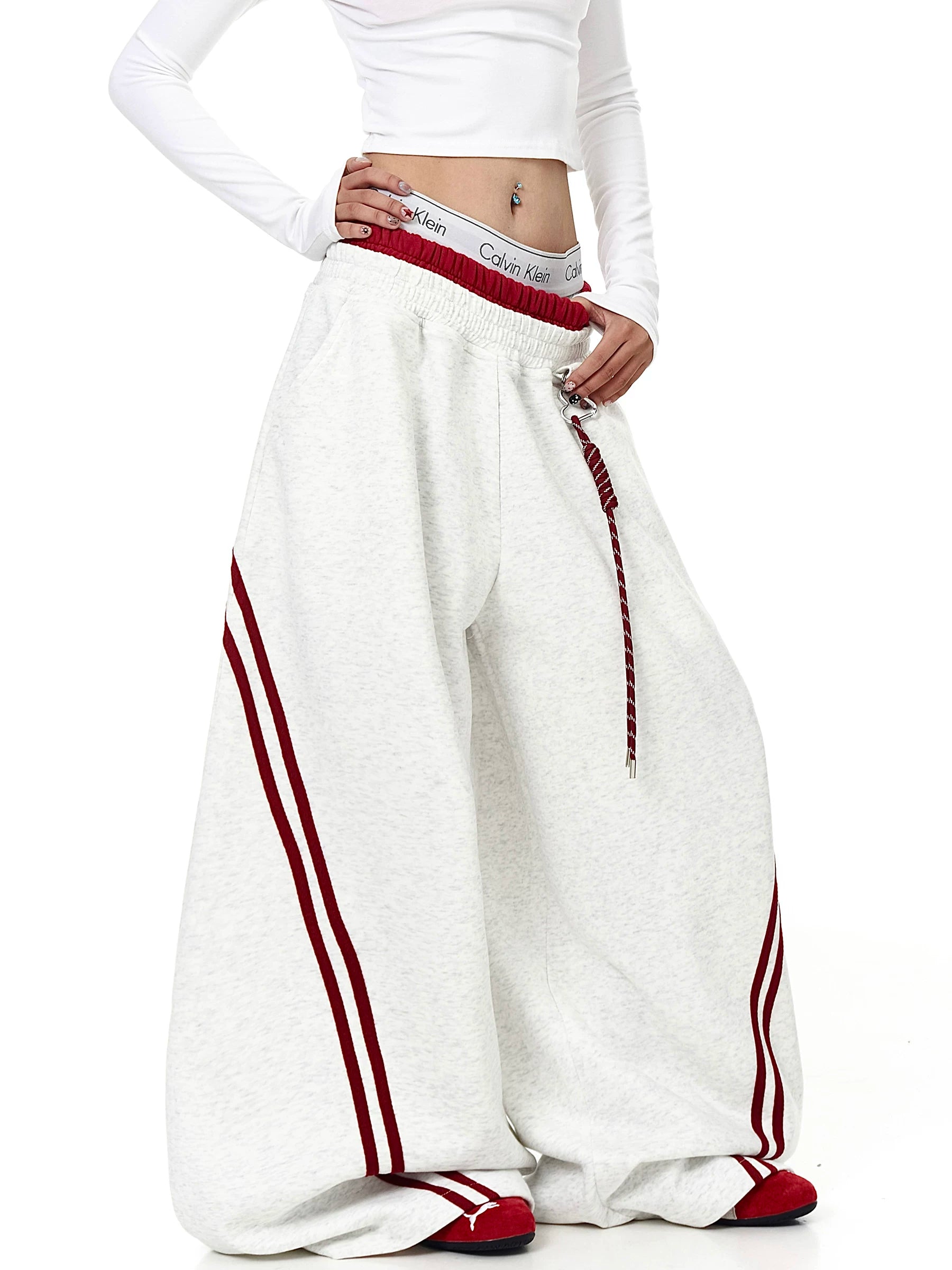 Model wearing gray striped curved wide-leg sweatpants, front angle - Techwearofficial