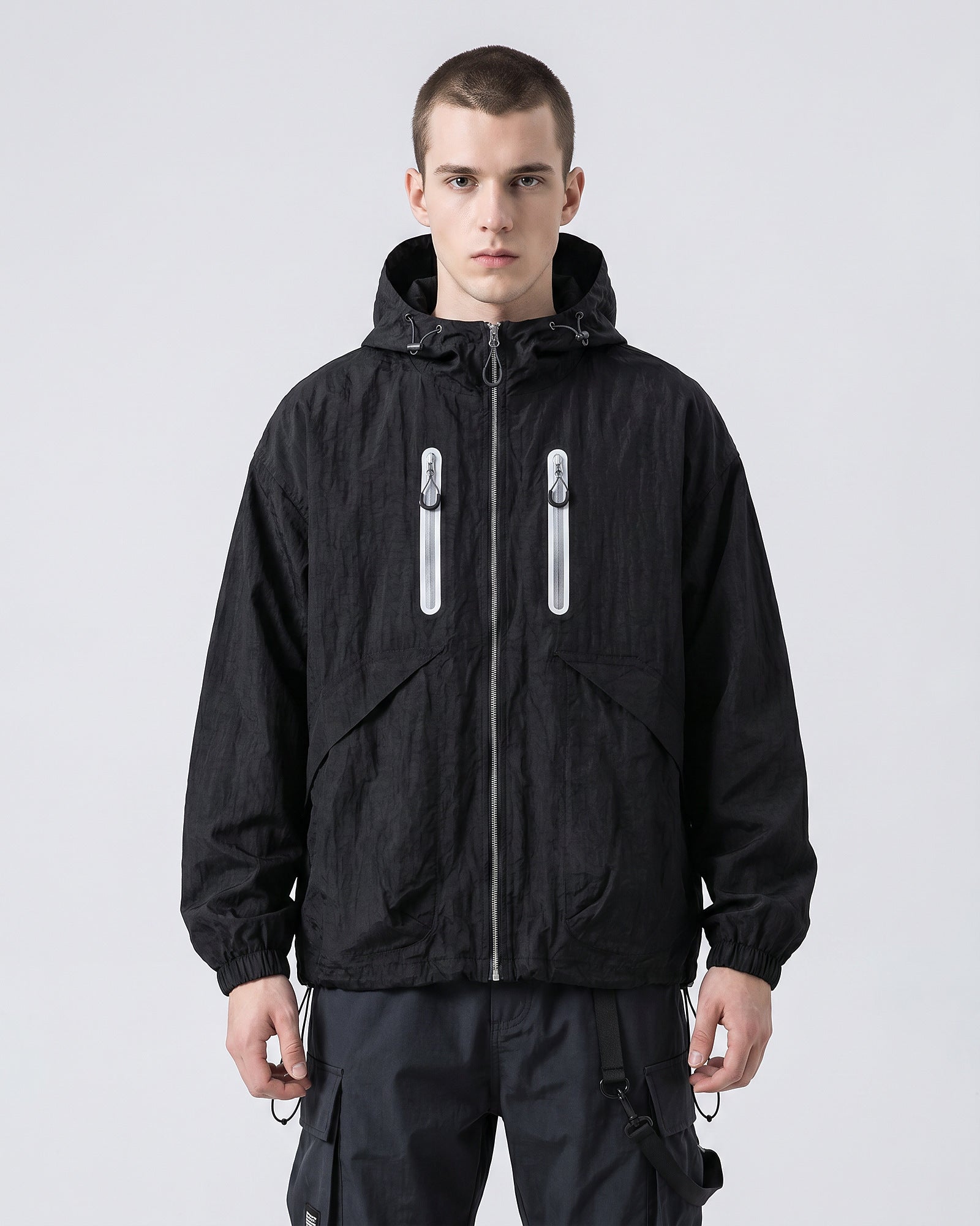 European male model in Obsidian Black hooded softshell windbreaker jacket, front view, clean studio e-commerce