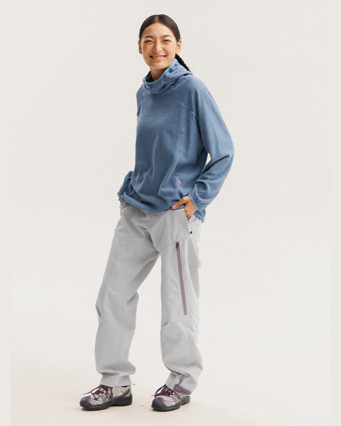 Woman wearing Skyline Blue plush fleece hoodie with matching pants, full-length front view on light studio background