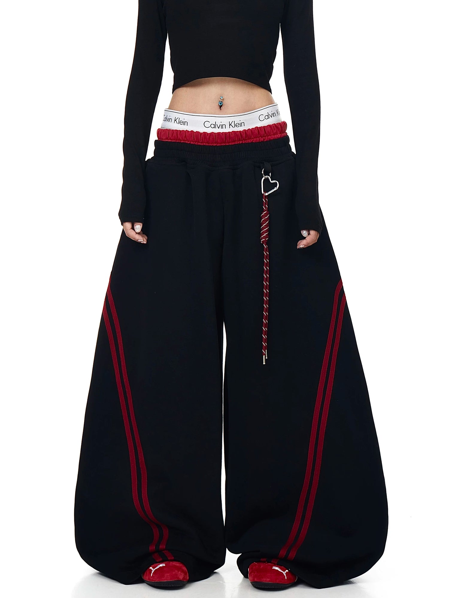 Model wearing black striped curved wide-leg sweatpants, front view - Techwearofficial