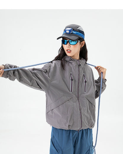 Woman wearing Rose Ash hooded softshell windbreaker jacket with drawcord hood, studio