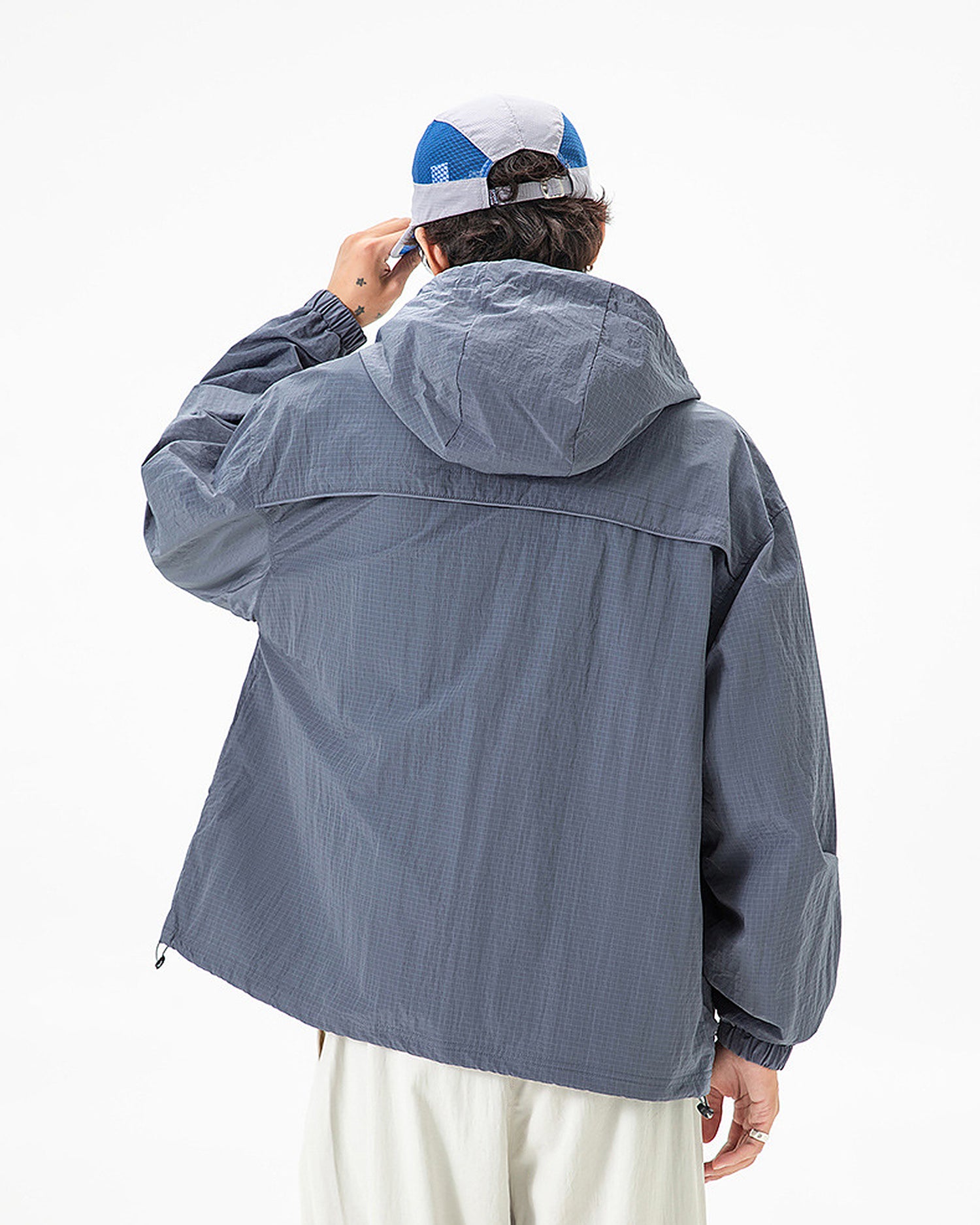 Back view of Alpine Blue hooded softshell windbreaker jacket showing rear vent flap and hem drawcord