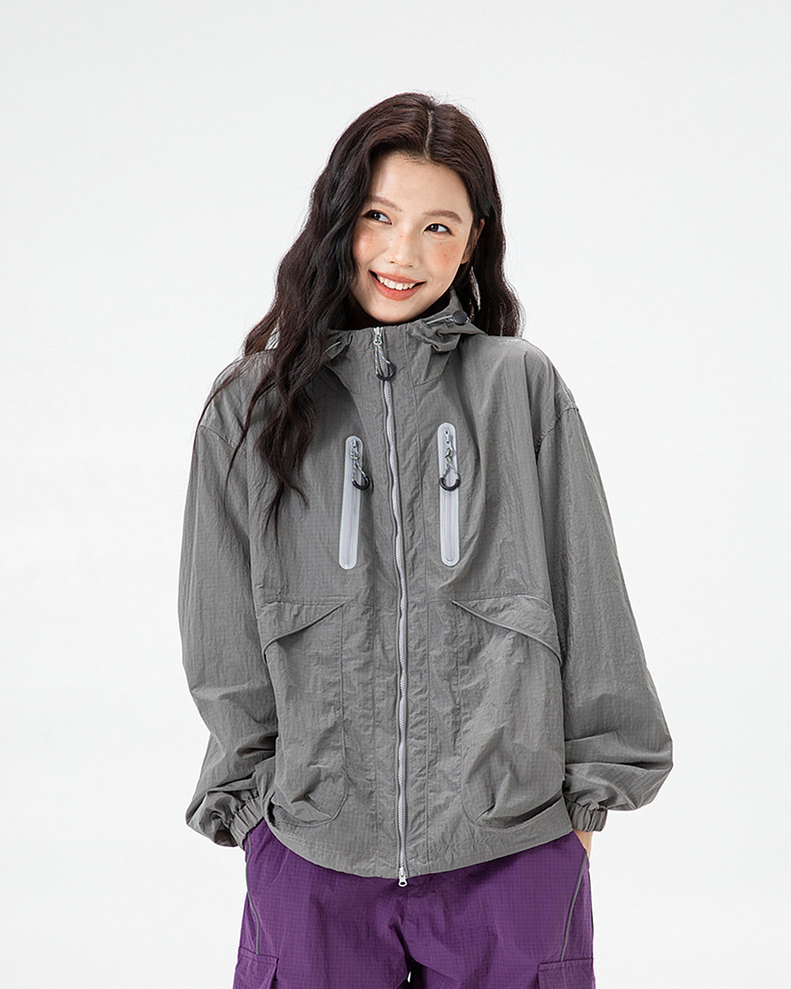 Woman wearing Shadow Grey hooded softshell windbreaker jacket, front view, studio