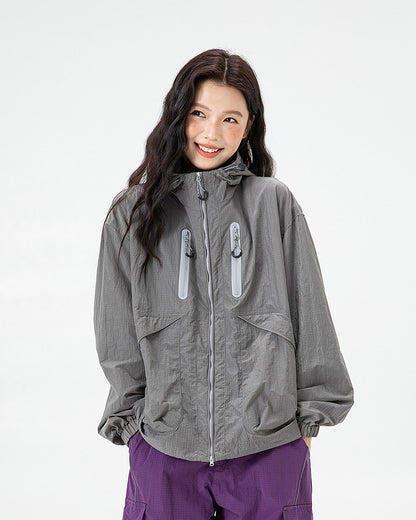 Woman wearing Shadow Grey hooded softshell windbreaker jacket, front view, studio