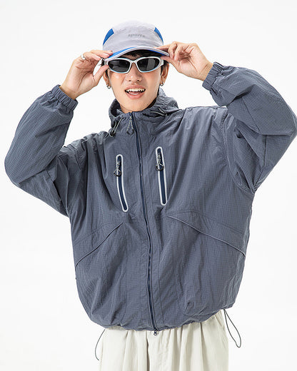 Man wearing Alpine Blue hooded softshell windbreaker jacket front view, urban techwear outdoor studio