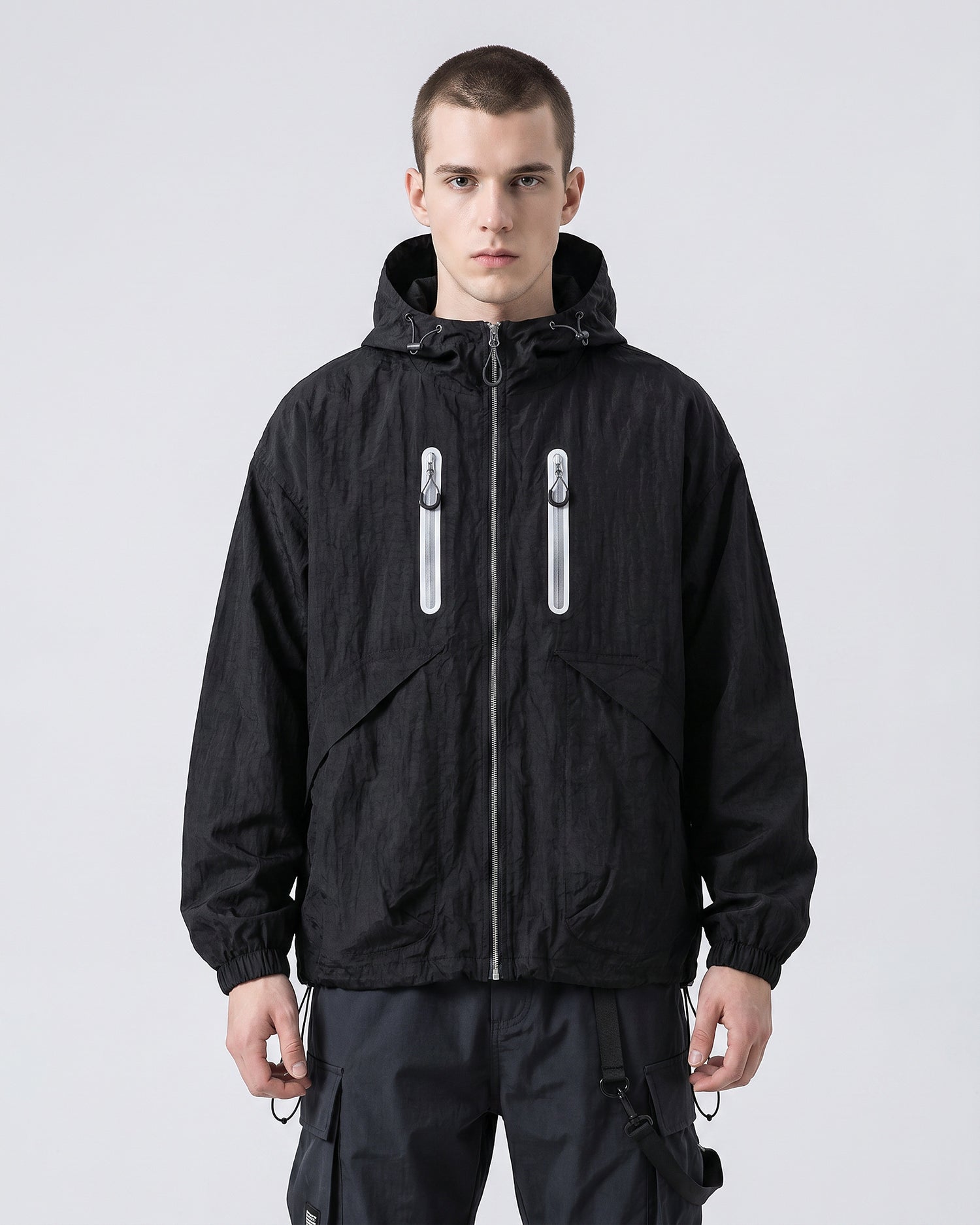 European male model in Obsidian Black hooded softshell windbreaker jacket, front view, clean studio e-commerce
