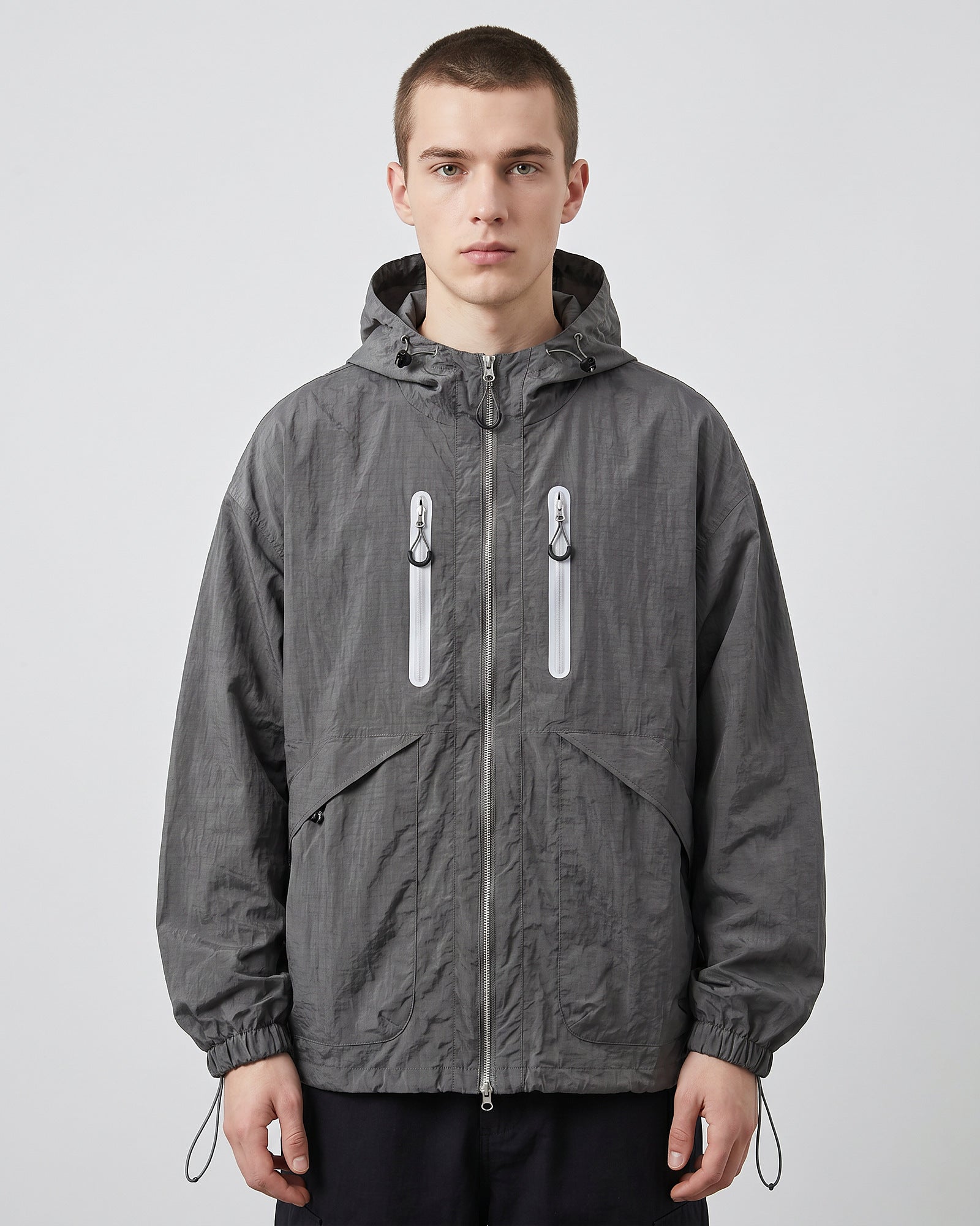 European male model in Shadow Grey hooded softshell windbreaker jacket, front view, clean studio e-commerce