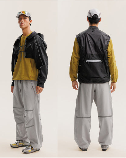 Midnight Black detachable inner vest of the 2-in-1 jacket worn alone, front and back views showing back reflective zip pocket, on male model