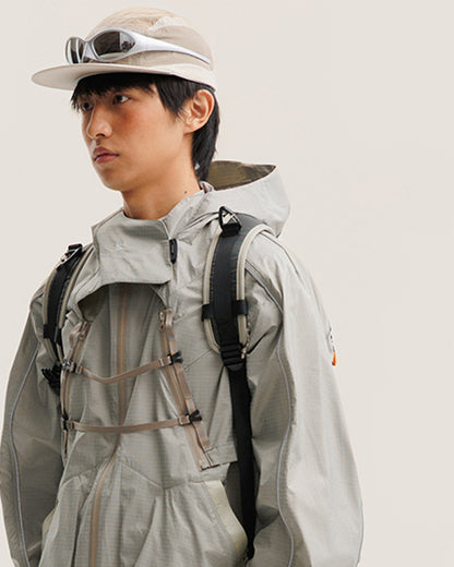 Sandstone Khaki 2-in-1 detachable hooded jacket combined form on male model with backpack, chest webbing buckles, outdoor techwear half body