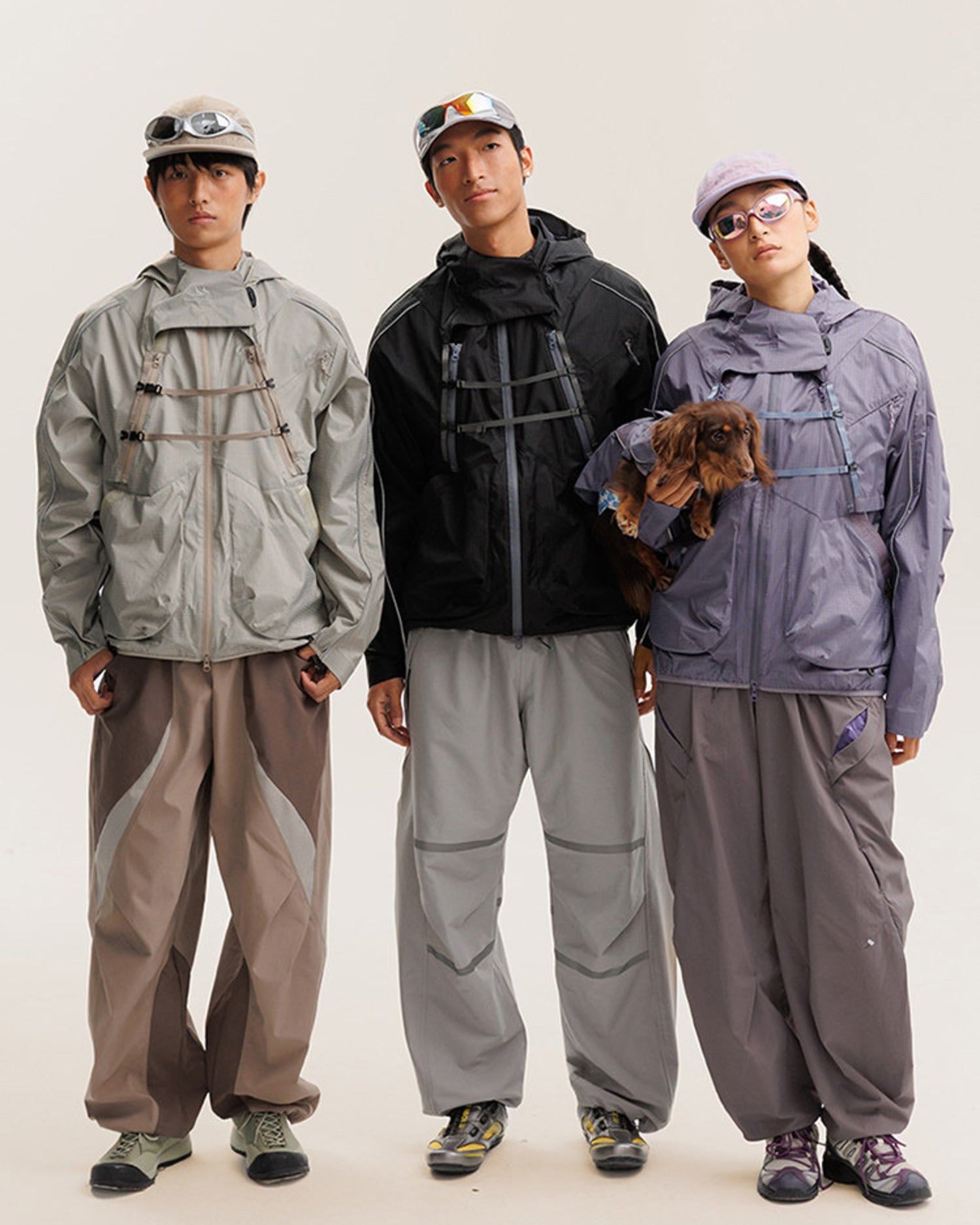 2-in-1 detachable hooded techwear jacket worn by three models in Sandstone Khaki, Midnight Black and Mist Lavender, outdoor lifestyle group