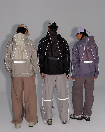 Back view of three models in the 2-in-1 detachable jacket showing reflective piping and back reflective zip pockets glowing, night-ride techwear